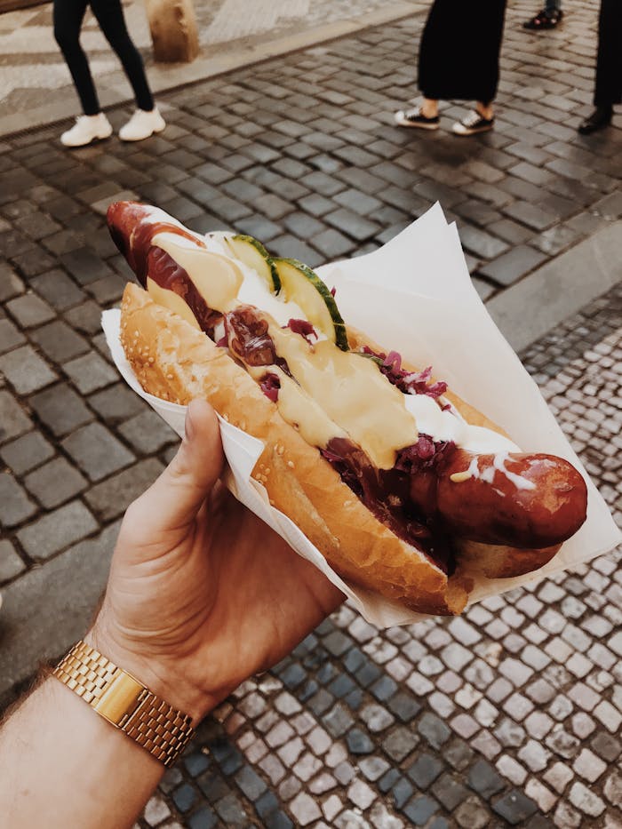Enjoy a delicious hotdog in Prague showcasing traditional Czech street food flavors.